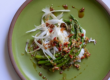 Asparagus bibimbap arranged neatly on a plate