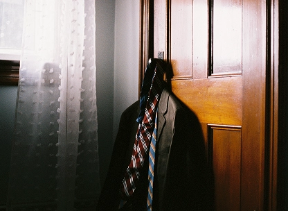 A suit an ties hang on a door