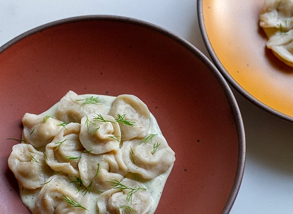 Pelmeni dumplings in a creamy dill sauce