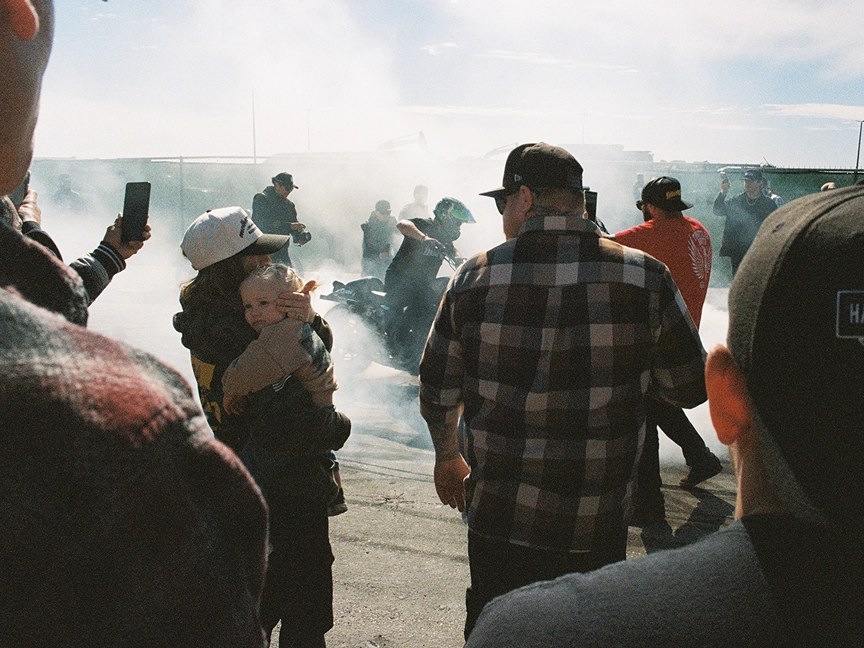 A crowd watches motorcyclists perform at Chopperfest 2025